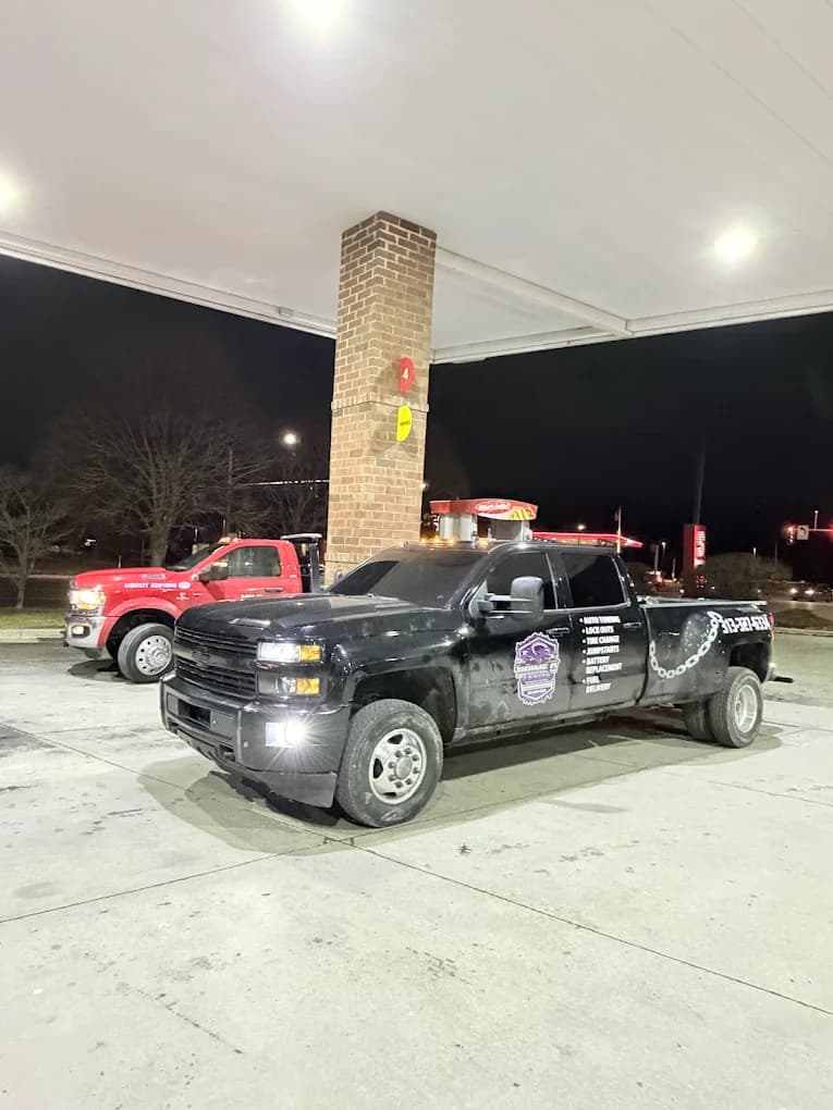 Prime O Towing dually wheel-lift Silverado refueling at a Metro Detroit gas station overnight