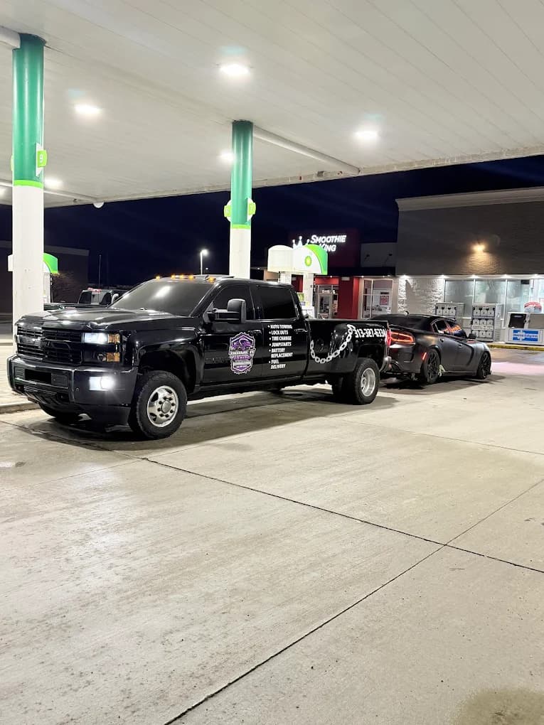 Prime O Towing wheel-lift Silverado completing an overnight emergency tow at a BP gas station in Metro Detroit